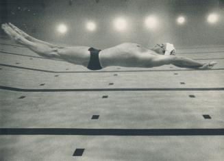 Mrs. Submarine, Sean Murphy swims six feet below surface as he practises 100-metre backstroke. The technique helped him to Commonwealth record