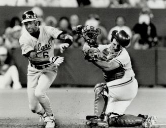 Out at home, Jays catcher Greg Myers loses his hat but hangs on to ball to tag out Oakland's Willie Wilson in the sixth inning last night