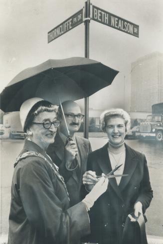 Image shows three people standing at the intersection of Thorncliffe and Beth Nelson Drive.