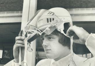 Passport to NHL? Greg Neeld, former Marlboro defenceman who lost an eye in 1973, demonstrates special face mask which he hopes will convince National (...)