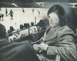 Greg Neeld, whose left eye was removed in an operation after he was struck by a hockey stick in a game at Kitchener, watches the last few minutes of a(...)