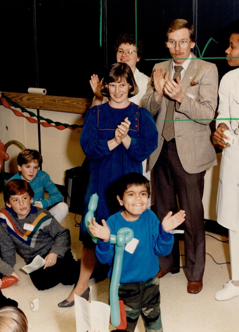 Nelles joins in the fun. Nurse Susan Nelles, pregnant with her first child, joins in applause for entertainers at a Christmas party yesterday sponsore(...)