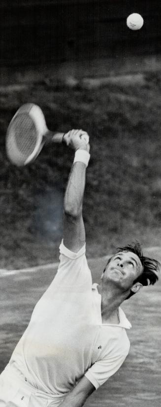 Power personified. Australian professional John Newcombe, top-seeded men's singles star in Canadian open tennis championships, whips racquet through a(...)