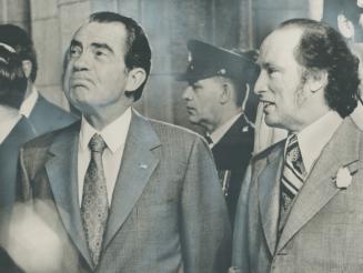 Pursing his lips and looking as curious as any tourist on Parliament Hill, President Richard Nixon accompanies Prime Minister Pierre Trudeau to this m(...)