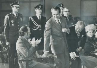 U.S. president Richard Nixon rises to speak on his arrival at Uplands Airbase, Ottawa, last night, flanked by Prime Minister Pierre Trudeau, Governor-(...)