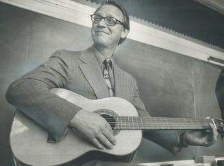 Liberal leader Robert Nixon strums on a guitar while campaigning in Ryerson Public School in Toronto