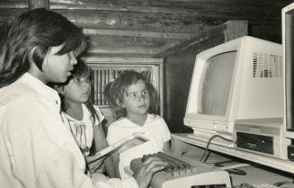 School computers - Vicki Kwandibens, 13 using keyboard, is watched by Christine and Miranda Roundhead, age 5 and 3