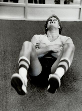 Hey, this is tough, Rookie defenceman Gary Nylund strains his way through some sit-ups (although he didn't quite make this one) during some heavy phys(...)