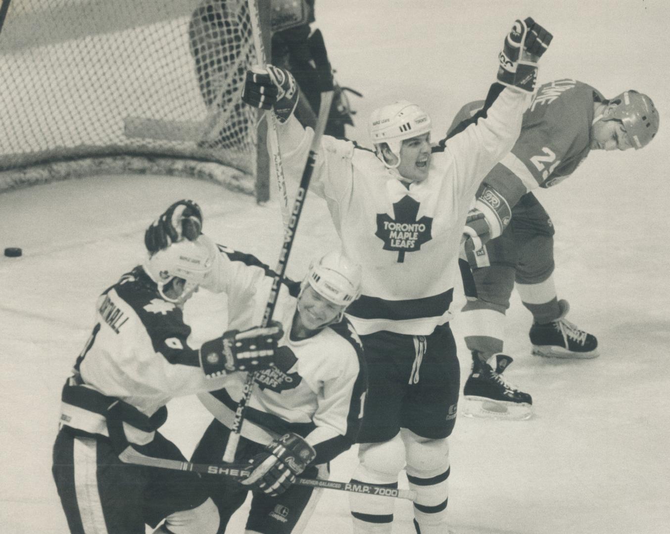 How sweet it is! Ed Olczyk of Maple Leafs waves his arms in joy Courtnall, shown at left celebrating with Gary Leeman, had potted the 5-4 goal against(...)