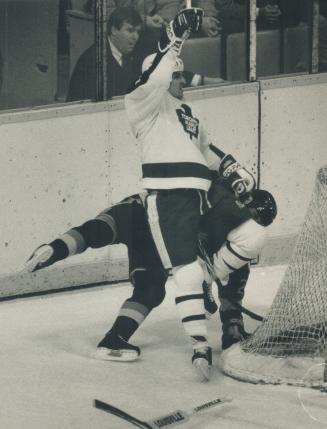 Eddie in action, The Leafs' Eddie Olczyk lowers the boom on Vancouver's Randy Boyd last night at the Gardens