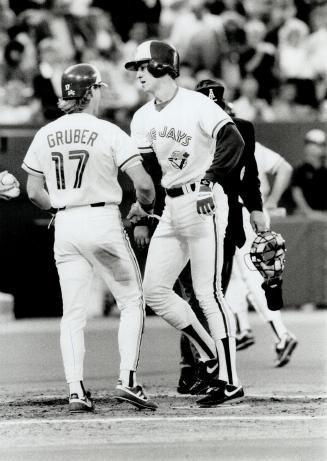 Happy 13th, Kelly Gruber welcomes home John Olerud after the Jay rookie hit his 13th homer of the season in third inning