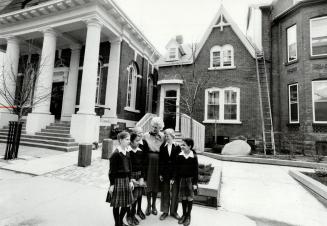 At right, Betty Oliphant - Miss O, as she's called at the school - with some of her students in the courtyard