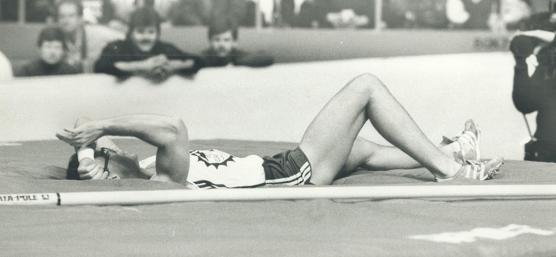 Ignominious end, Pole-vaulter Bill Olson lies on the mat after failing in his third and final attempt at 5