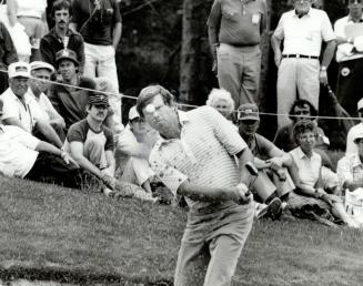 In the hunt, Briton Peter Oosterhuis makes a fine shot from the sand trap on this play