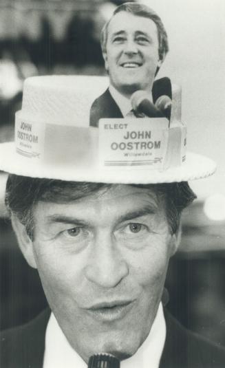 He's may man, John Oostrom didn't wear his party affiliation on his sleeve, but on his head and it bore the grinning face of Brian Mulroney. Oostrom w(...)