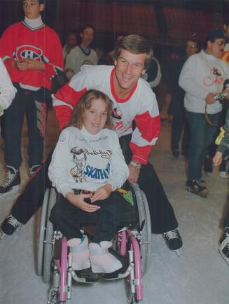 Great skate, Bobby Orr takes Sabrina LeVear, 8, on a lap around the ice at Maple Leaf Gardens yesterday