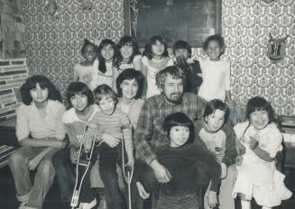 One big happy family, J.J. (Joshua Jonathan) Osborne, 5, with crutches, sits on mother Gina's knee, with dad Ray next to him. Others in the Osborne fa(...)