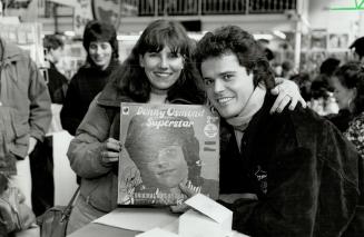 Signed at last. Dianne Vance, 27, got her childhood idol Donny Osmond to sign album she kept since 1973 at record store signing yesterday. Musical 'Jo(...)