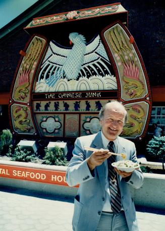 Happy eating, Walter Oster, president of The Whalers Group, tries a bowl of fried rice in front his new seafood restaurant. Inside The Chinese Junk is(...)