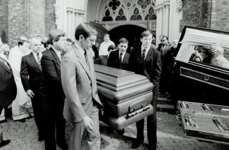 Final journey, Pallbearers, five brothers and a brother-in-law, carry Sean O'Sullivan's coffin from the cathedral to a waiting hearse. The priest was buried in Hamilton