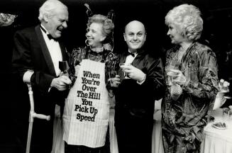Right, Wade Hampton, past president of the Ontario March of Dimes, gets a kick out of Bluma Appel's apron, while artist Charles Pachter and Jacqueline Hampton also enjoy the joke