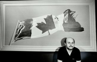 Artist and flag, Charles Pachter poses in front of one of his Painted Flags