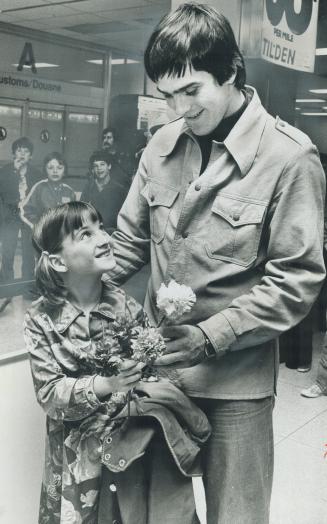 Welcome home, uncle wilf, Wilf Paiement of Colorado Rockies gets a flower from his niece, Chantel Desforges 7, on his arrival at Toronto International Airport yesterday