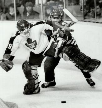 Best foot out, Toronto Maple Leafs' goaltender Mike Palmateer sticks his left foot out to throw a block on Paul Lawless of Hartford Whalers behind the(...)
