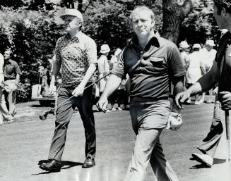 Mark McCormack (left) is seen here striding on golf course with the athlete who was the foundation of his empire-Arnold Palmer. [Incomplete]