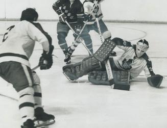 Bernie Parent, Maple Leafs' goaltender, is shown here in action and resting alertly on sidelines