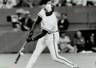 Fore!, Jays' Dave Parker would have been at home on the golf course on this swing as he misses a low pitch from California Angel Mike Fetters. But Jay(...)