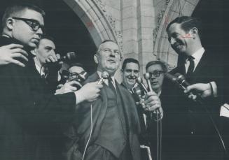 After his victory in the House of Commons, in which government won confidence vote 138-119, Prime Minister Pearson talks with newsmen outside Parliament