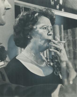 All wifely attention is Mrs. Lester Pearson as she listens to her husband, leader of the Liberal party, open the eight-week federal election campaign (...)