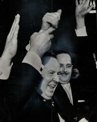 Cheers. A jubilant Liberal Leader Lester Pearson has his arm raised by happy supporters after House twice voted 142-111 to topple P.C. government