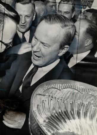 Prime minister Lester B. Pearson happy leaf fan. Toronto team hasn't lost at Gardens this season with P.M. there