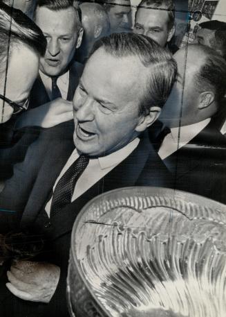 Prime minister Lester B. Pearson happy leaf fan. Toronto team hasn't lost at Gardens this season with P.M. there
