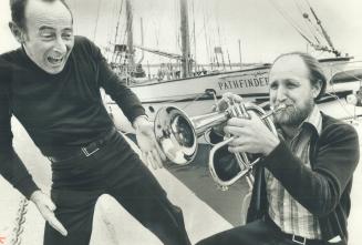 Art's alive at harbourfront. Bruce Cassidy of the Doug Riley Quintet limbers up on his horn as Adrian Pecknold mimes his appreciation in front of a sa(...)