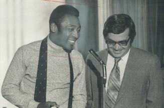 HIghest paid athlete in world, famed Pele of Brazil's Santos soccer club holds press conference at Toronto Men's Press Club with aid of interpreter Je(...)