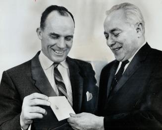 W. D. Whitaker presents cheque for $500. Star's Joe Perlove (right) accepts for Sportsmen's Corner