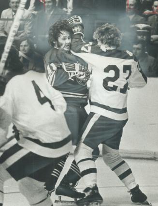 Crunch! Face of Gil Perreault, young star of Buffalo Sabres, is distorted as he absorbs a jolt on side of jaw from Darryl Sittler (27) of Maple Leafs (...)