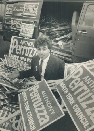 Signs of the times, Anthony Perruzza, a candidate for North York council, displays some of the hundreds of stolen lawn signs recovered at York University