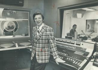 Norm Perry, television personality, models black and white check sports jacket with burnt orange overstripe