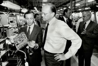 Ford boss visits, Donald Petersen, right, president of U