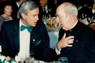 Greening of the Premier, Sporting a green bow tie for Saint Patrick's Day, Ontario Premier David Peterson talks with Emmett Cardinal Carter at a fund-(...)