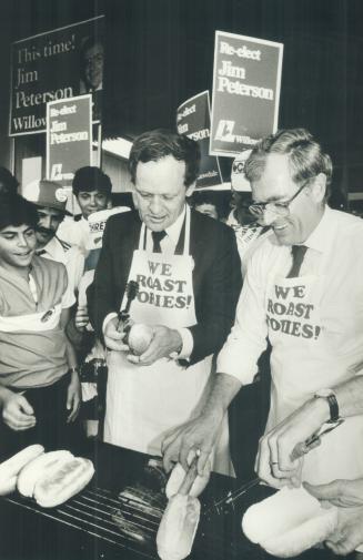 Dogging voters, Jean Chretien prepared hot dogs with Jim Peterson, seeking re-election in Willowdale, in North York yesterday. Chretien played down sp(...)