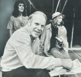 Len Peterson at work on the set of his new play, Women in the Attic, which opens tonight at Toronto Workshop Productions. Behind him are the show's two stars, Sylvia Lennick (right) and Peggy Graham