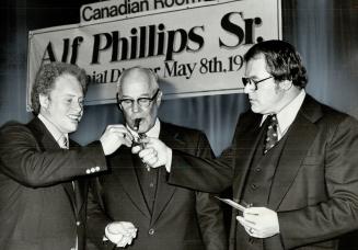 You light up my cigar, Sons Dave (left) and Alfie, stoke up Alf Phillips' cigar at testimonial dinner to honor him for 50 years as a champion diver an(...)