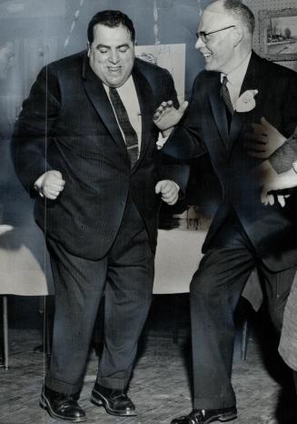 Titanic Twist. Ald. Joe Piccininni (left) and Ian Wahn, Liberal candidate in St. Paul, demonstrate their skill at the new dance craze, The Twist. They(...)