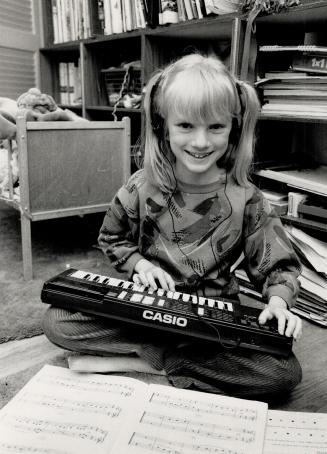 Work and play, Actress Sarah Polley, 9, known best for her role in the TV series Ramona, practises the piano on a small keyboard at home