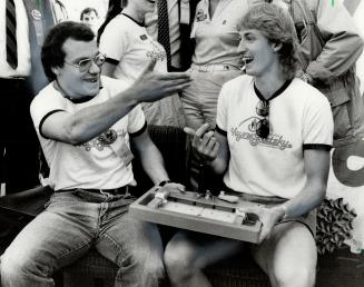 Beatcha, Star reporter Bob Pomerantz accepts the surrender of Wayne Gretzky after trouncing The Great at the Big Brothers of Metro Rocket Hockey tournament yesterday